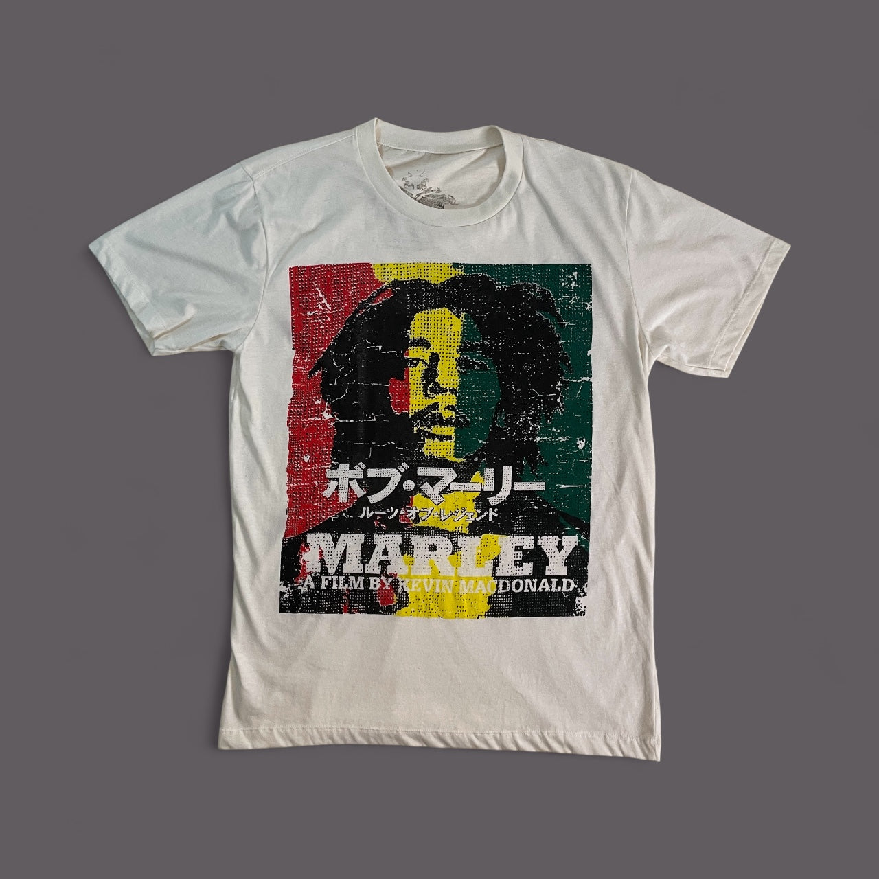 Maglietta bianca unisex in cotone con stampa del volto di Bob Marley ispirata al film documentario Marley (2012), grafica con colori rastafari e scritte giapponesi