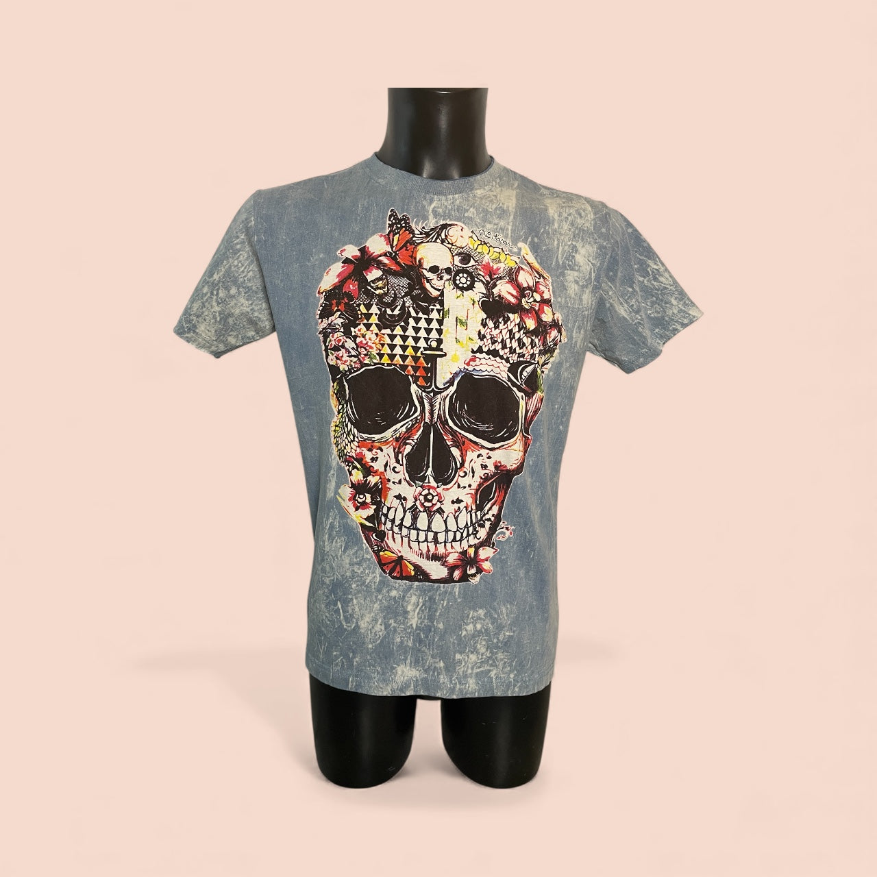 T-shirt stonewash blu con grande stampa teschio decorato da fiori e pattern artistici — maglietta unisex, on model1.
